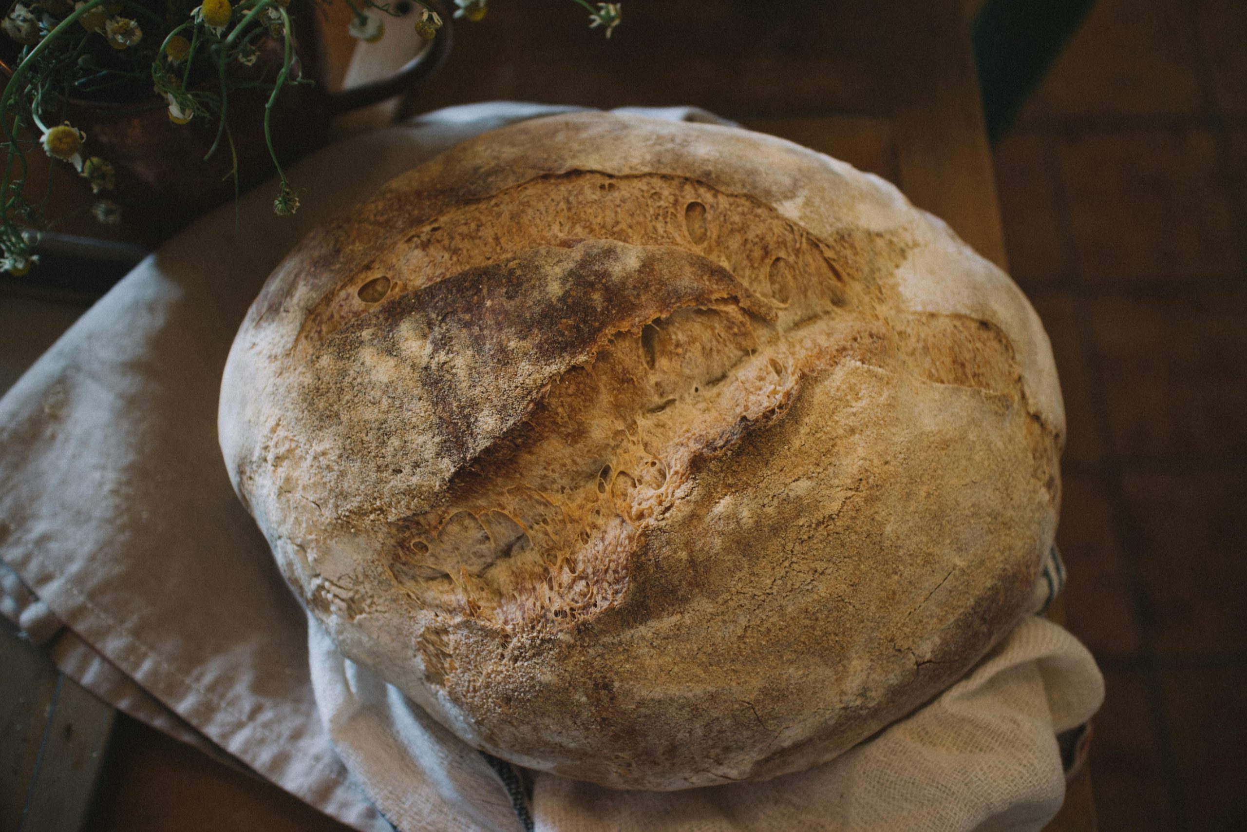 A close-up of homemade rustic sourdough bread, highlighting its texture and crust.