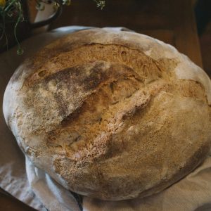 A close-up of homemade rustic sourdough bread, highlighting its texture and crust.